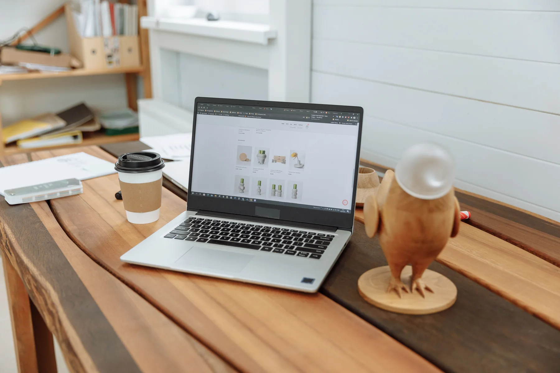 Laptop displaying a website on a wooden desk