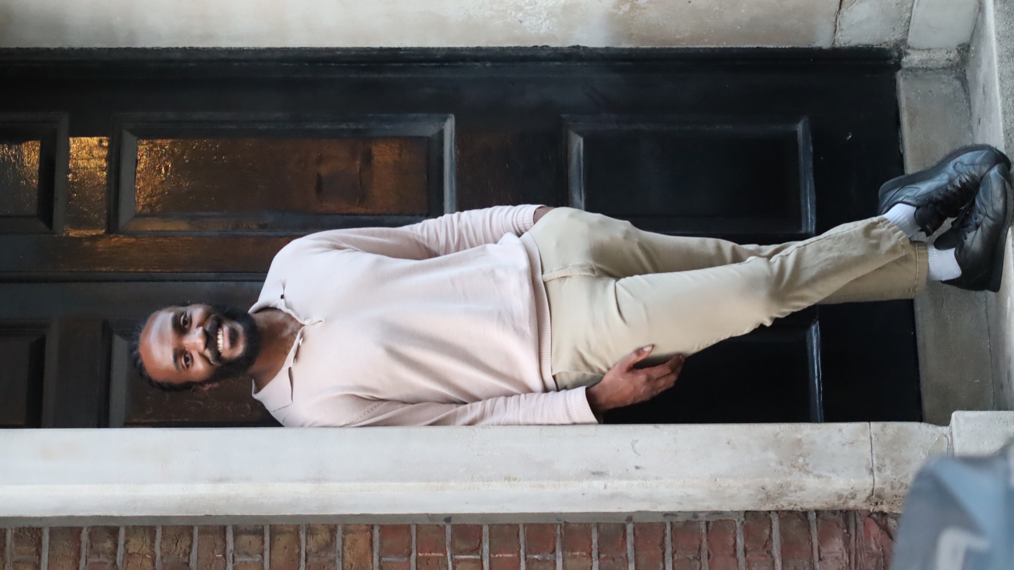 Marco smiling in a doorway