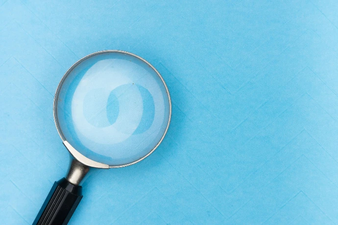 magnifying glass in front of blue background