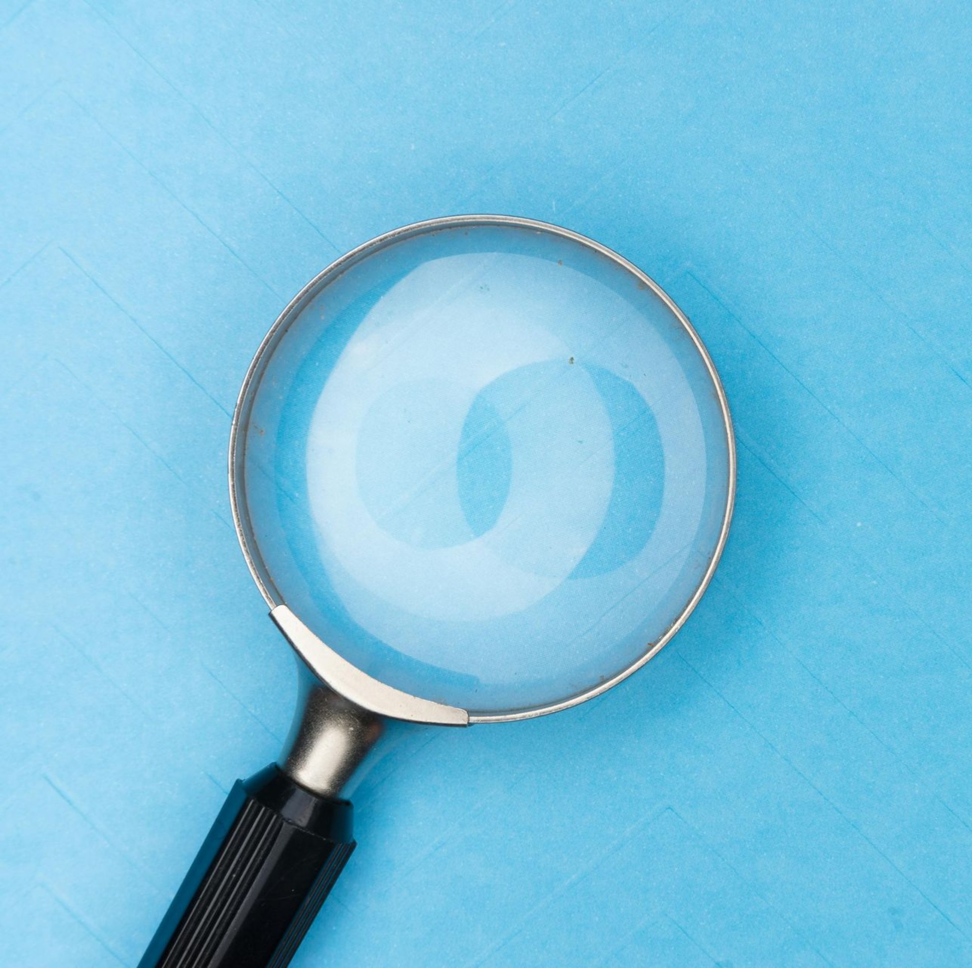 magnifying glass in front of blue background